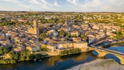an aerial view of a city with a bridge over a river at Maison accueillante à Trèbes avec 2 chambres in Trèbes