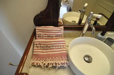 a towel on a counter next to a sink at Relais des Vignerons, Chambres d'hôtes in Conilhac-Corbières