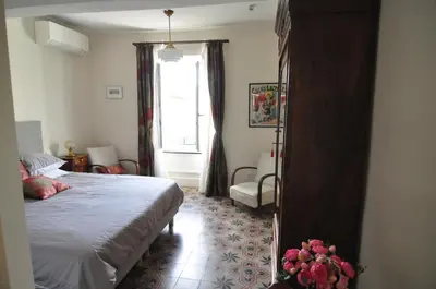 a bedroom with a bed and a window at Relais des Vignerons, Chambres d'hôtes in Conilhac-Corbières