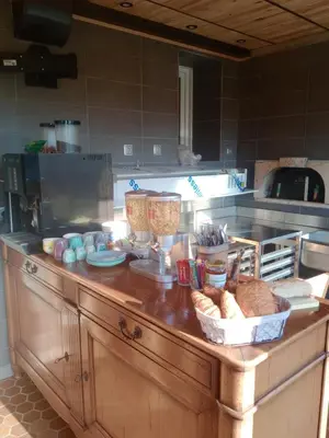a kitchen counter with bread and baskets on it at chambre et table d'hôte au coin de la cité in Carcassonne