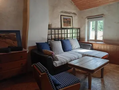 a living room with a couch and a coffee table at Appartement prémian in Prémian