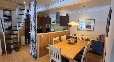 a dining room and kitchen with a table and chairs at Les Quatre Saisons in Montaillou