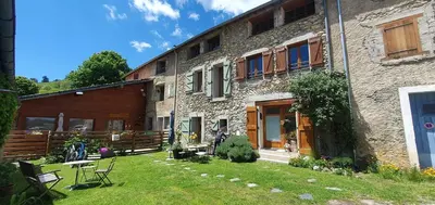a large stone building with a yard and a building with a yard at Les Quatre Saisons in Montaillou