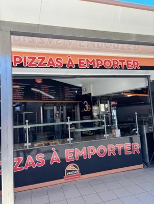 a pizza as a emporium with a sign in the window at Charmant T2 à 1 min de la plage in Port-la-Nouvelle