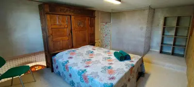a bedroom with a bed with a blue comforter at De l'étang de BAGES au massif de la Clape in Narbonne