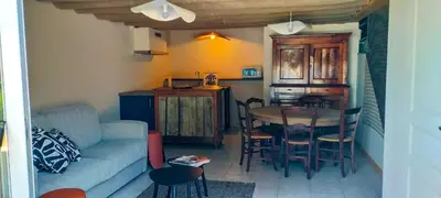 a living room with a couch and a table at De l'étang de BAGES au massif de la Clape in Narbonne