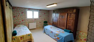 a small bedroom with two beds and a window at De l'étang de BAGES au massif de la Clape in Narbonne