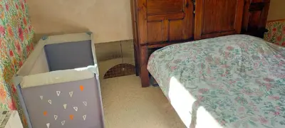 a bedroom with a bed and a dresser next to it at De l'étang de BAGES au massif de la Clape in Narbonne