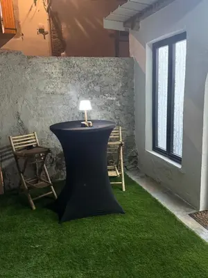 a table with a lamp on top of green grass at Tanabata logde in Pezens