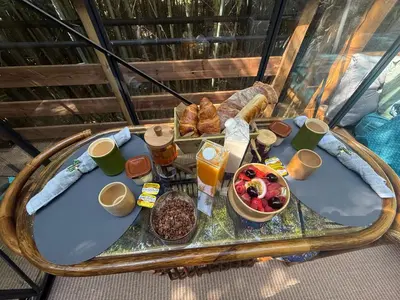 a table with food on it on a balcony at Tanabata logde in Pezens