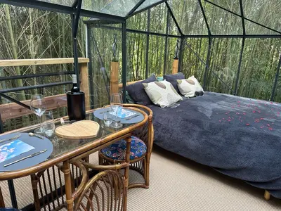a room with a bed and a table in a tent at Tanabata logde in Pezens