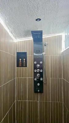 a shower in a bathroom with a ticket machine at Tanabata logde in Pezens