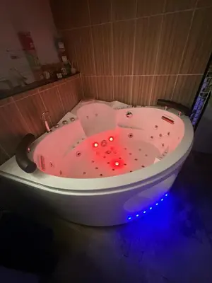 a pink bath tub with red lights in a bathroom at Tanabata logde in Pezens