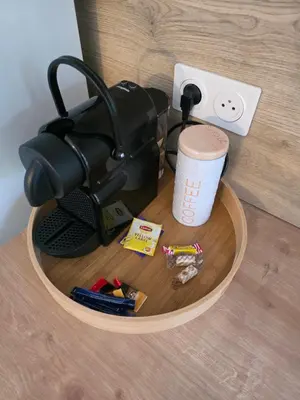 a coffee maker sitting on top of a wooden table at Studio hypercentre in Castelnaudary