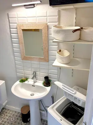 a small bathroom with a sink and a mirror at Studio équipé in Narbonne