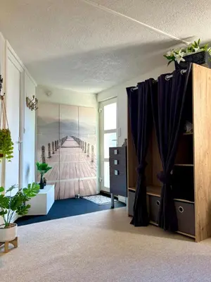 a room with purple curtains and a view of a pier at Studio équipé in Narbonne