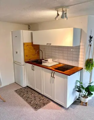 a kitchen with a sink and a white refrigerator at Studio équipé in Narbonne