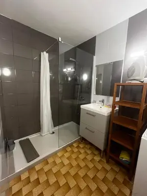 a bathroom with a shower with a glass door at Bel appartement proche de la mer in Port-la-Nouvelle