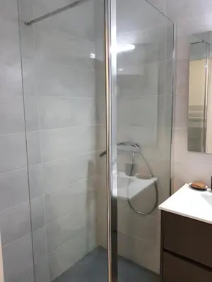 a shower with a glass door in a bathroom at Gruissan appartement Haut Standing in Gruissan