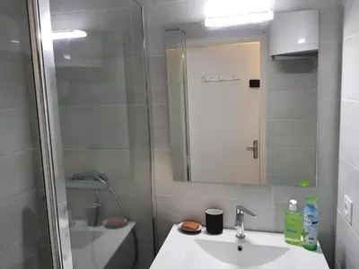 a bathroom with a sink and a shower and a toilet at Gruissan appartement Haut Standing in Gruissan