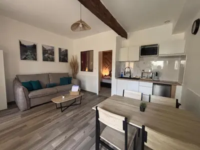 a living room with a couch and a table at Chez Mel et Garry in Villedaigne