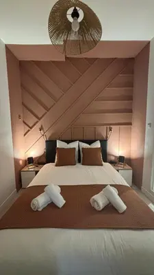 a bedroom with a large bed with two white pillows at Chez Mel et Garry in Villedaigne