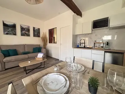 a living room with a couch and a table at Chez Mel et Garry in Villedaigne