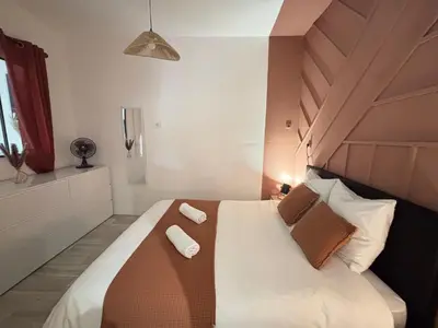 a bedroom with a bed with two towels on it at Chez Mel et Garry in Villedaigne