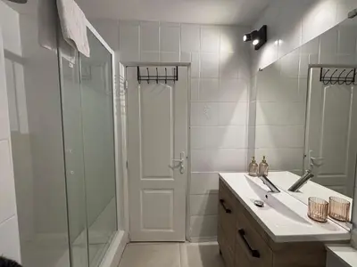 a bathroom with a shower and a sink and a mirror at Chez Mel et Garry in Villedaigne