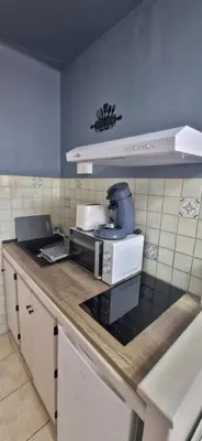 a kitchen with a coffee maker on a counter at Studio rénové à 70m de la plage in Port-la-Nouvelle