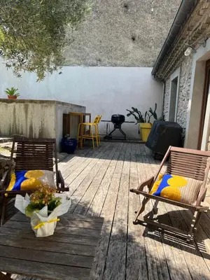 two chairs sitting on a wooden deck at Chambre À la croisée des sens in Carcassonne