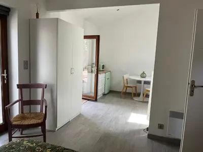 a living room with a chair and a table at Chambre À la croisée des sens in Carcassonne