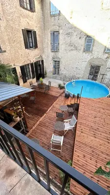 a bedroom with a bed and a table and a window at Dreamhome B&B Limoux in Limoux