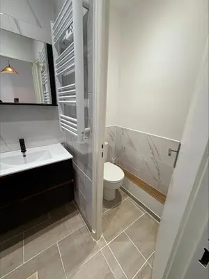 a white bathroom with a toilet and a sink at Lylo in Carcassonne