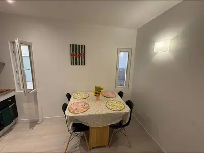 a dining room with a table with plates on it at Lylo in Carcassonne