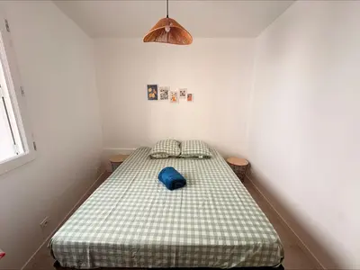 a bedroom with a bed with a blue pillow on it at Lylo in Carcassonne