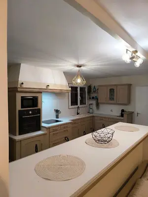 a kitchen with a large white island in a kitchen at Maison calme avec piscine in Montredon