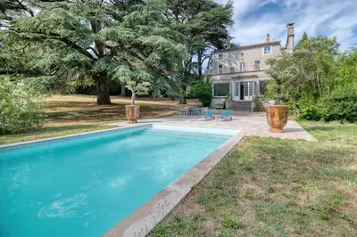 a swimming pool in front of a house at Villa Corbière - Piscine Privée in Castres