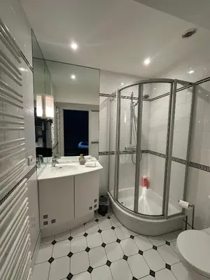 a bathroom with a shower and a sink and a tub at Villa Corbière - Piscine Privée in Castres