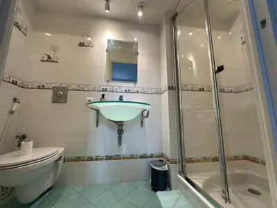 a bathroom with a toilet and a sink and a shower at Villa Corbière - Piscine Privée in Castres
