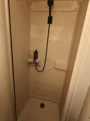 a bathroom with a shower with a phone on the wall at Maison entière Les Maisons de Gaia in Tuchan