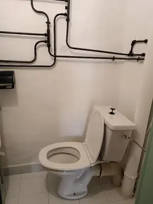 a bathroom with a white toilet and a sink at Maison entière Les Maisons de Gaia in Tuchan