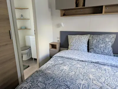 a small bathroom with a sink and a bed at Mobil home 6 à 8 personnes climatisé in Saint-Papoul