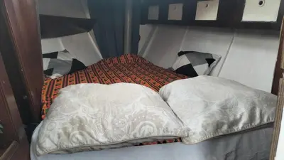 a bed with two pillows in a room at AMADONNe in Gruissan