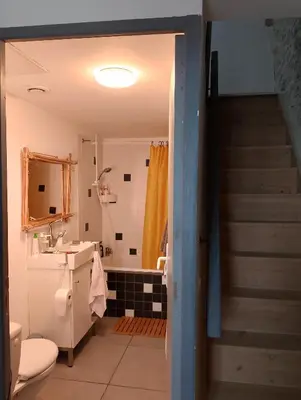 a bathroom with a staircase and a sink and a toilet at Jolie maison vintage, à 15mn de Lagrasse in Taurize