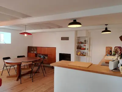 a kitchen and dining room with a table and chairs at Jolie maison vintage, à 15mn de Lagrasse in Taurize