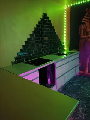 a room with a staircase with a purple and green lighting at Les cités romances Le Cléopâtre in Carcassonne