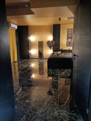 a lobby with a room with a bed and a sculpture at Les cités romances Le Cléopâtre in Carcassonne