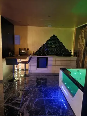 a room with a bar and an aquarium in a building at Les cités romances Le Cléopâtre in Carcassonne