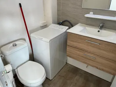 a small bathroom with a toilet and a sink at Studio rénové centre Gruissan - 2 pers, parking privé - FR-1-796-92 in Gruissan